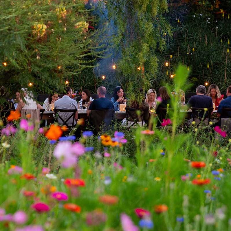 dinner on the event lawn beside the garden at apricot lane farms